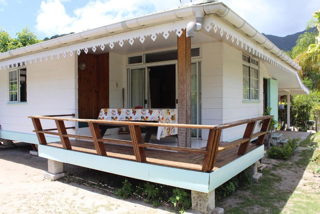 a small white house with a large porch at Fare Edith Moorea in Haapiti