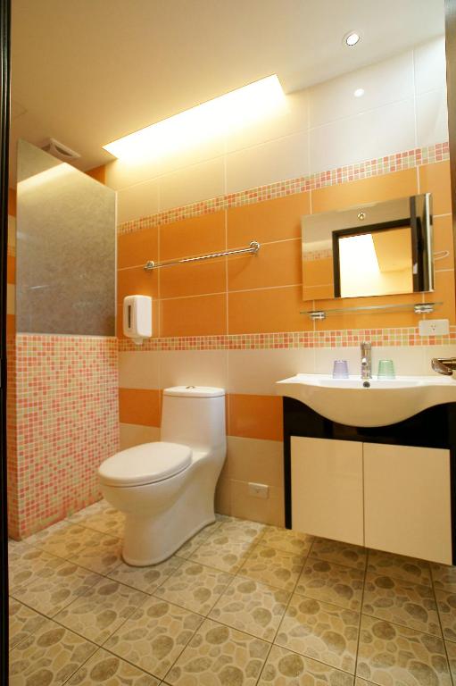 a bathroom with a toilet and a sink at Taitung Venice B&B in Taitung City