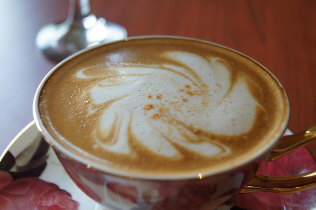 a cup of coffee sitting on a table at Taitung Venice B&B in Taitung City