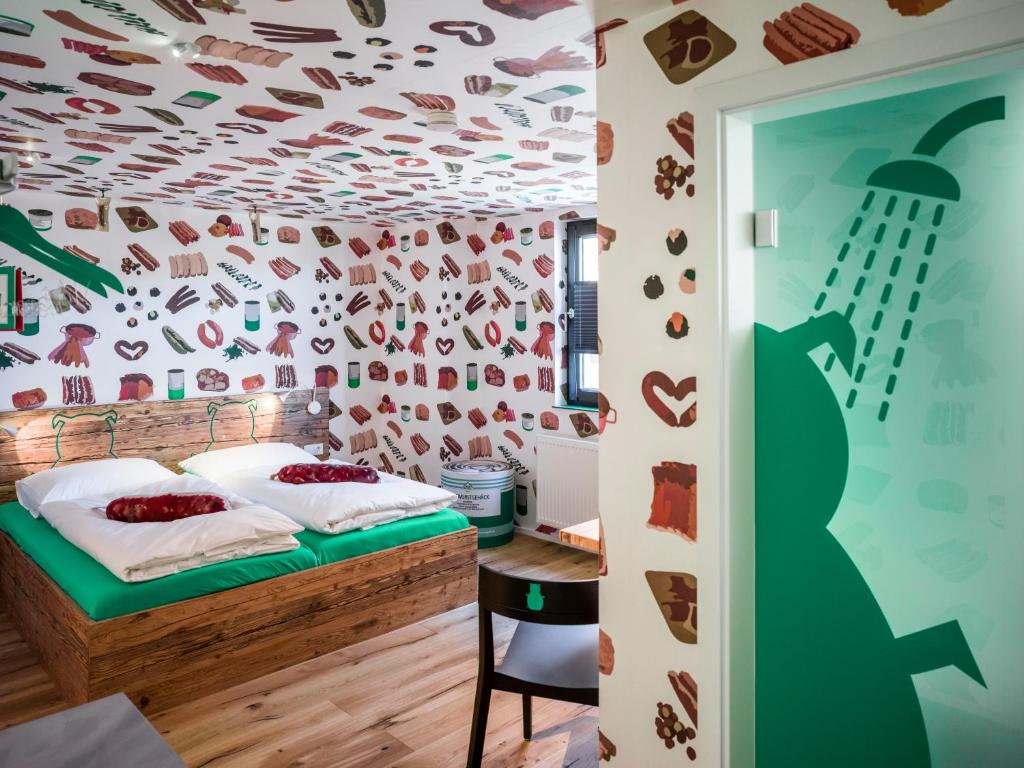 a bedroom with a bed and a wall with shoes on it at BRATWURSThotel in Georgensgmünd