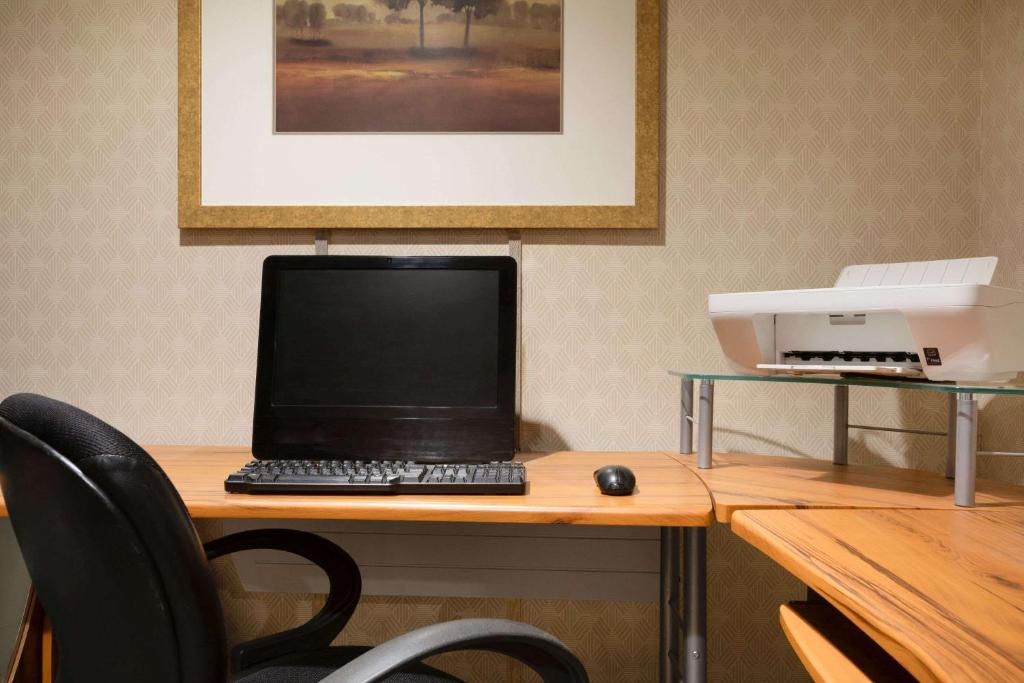 a laptop computer sitting on a desk with a printer at Days Inn by Wyndham Renfrew Conference Centre in Renfrew