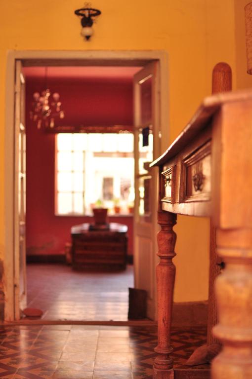 a hallway of a house with a door leading into a room at Hostal La Antigua in Humahuaca