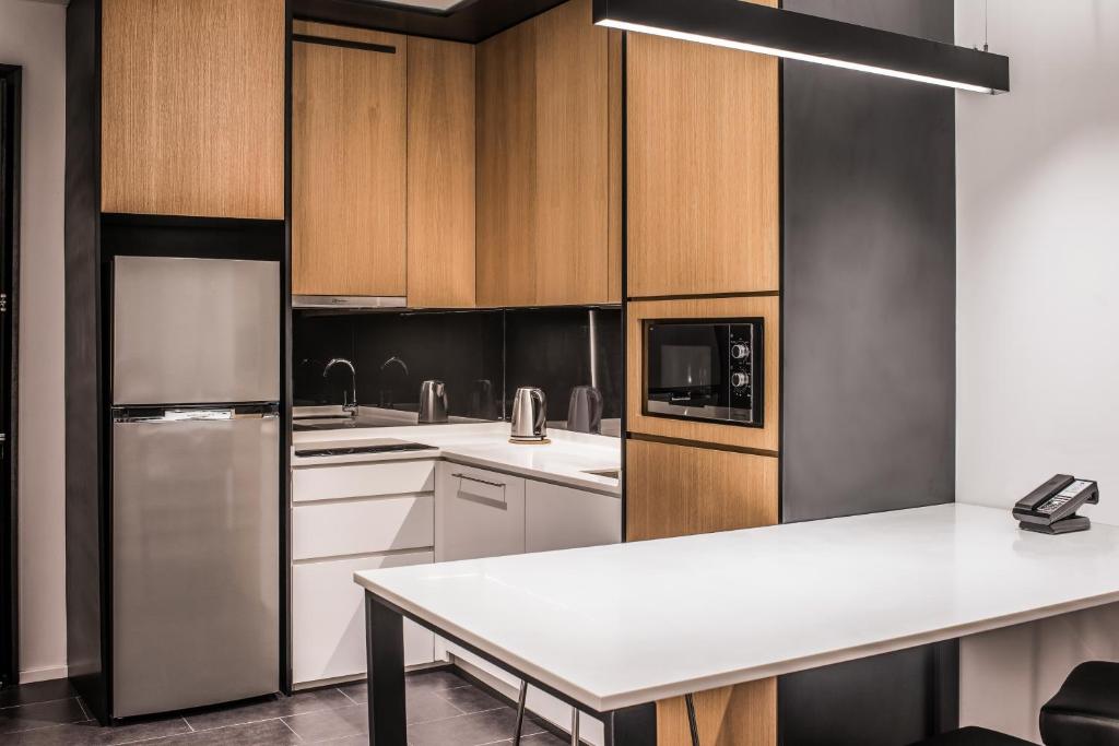 A built-in suite kitchen faces a broad island that doubles as a work or dining surface.