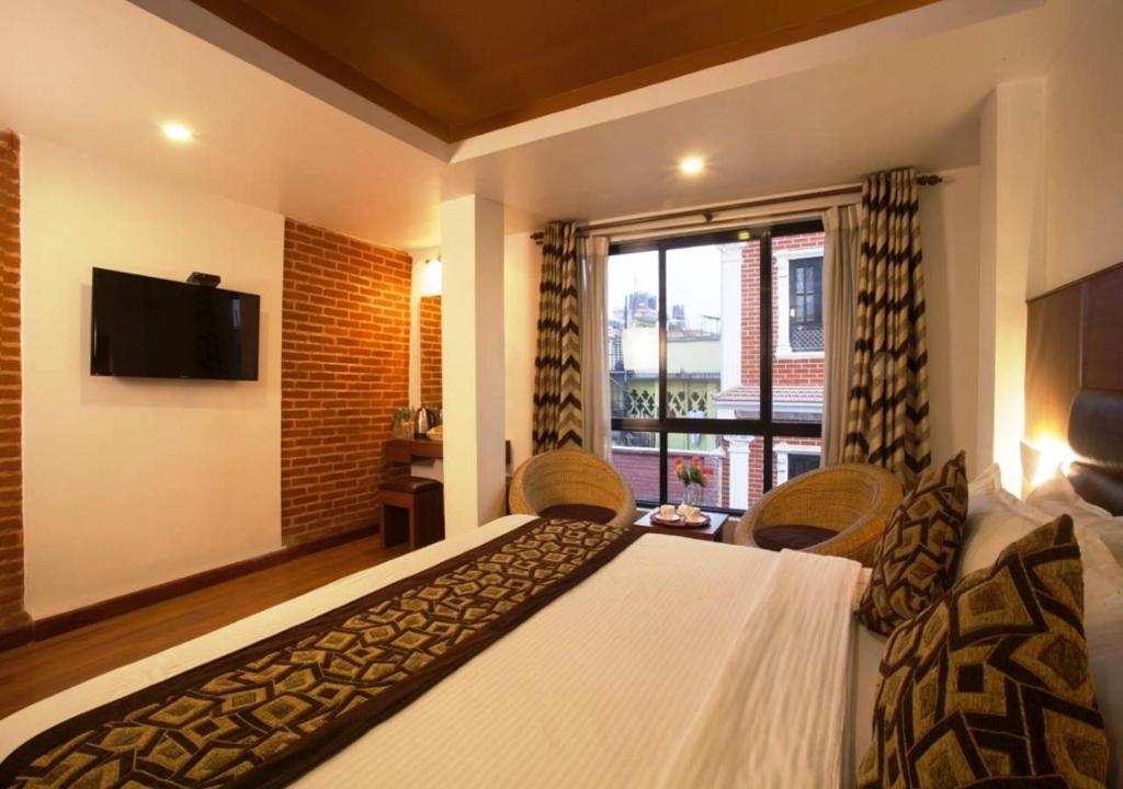 Postel nebo postele na pokoji v ubytování Hotel Shreesu