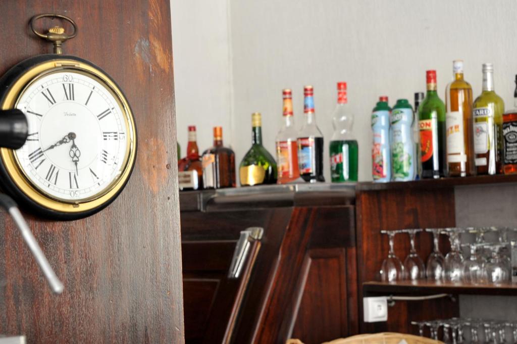 a clock on the wall of a bar at Grand Hôtel in Sainte-Foy-la-Grande
