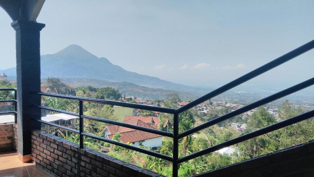 a room with a view of a city and mountains at Villa Raung Indah Tretes in Prigen