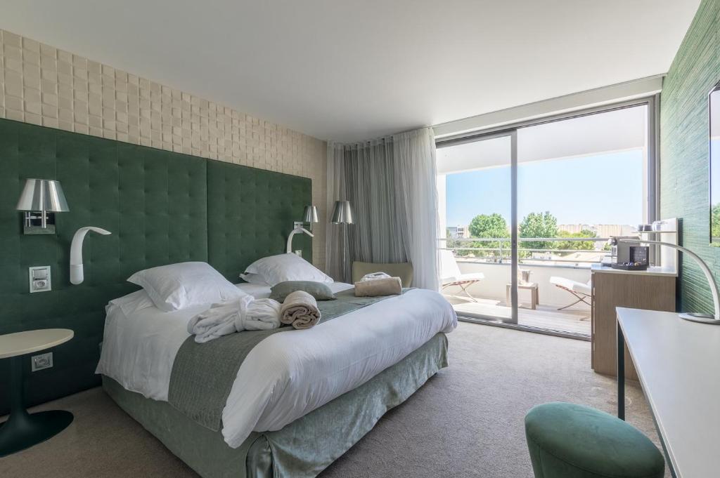 Postel nebo postele na pokoji v ubytování Oz'Inn Hôtel & Spa