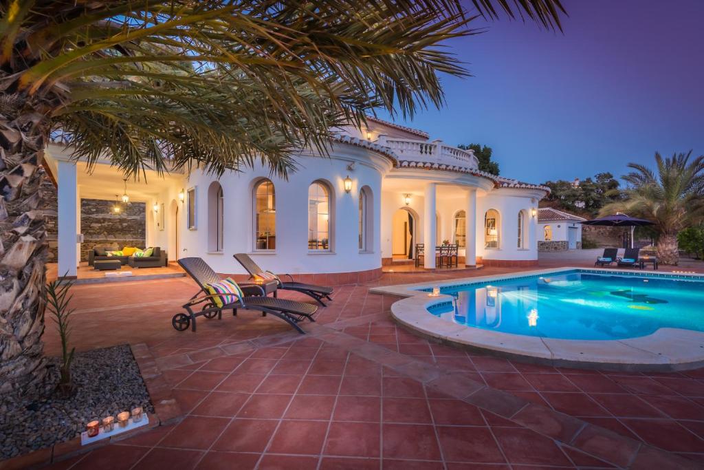 una casa con piscina en un patio en Villa El Ancla en Sayalonga