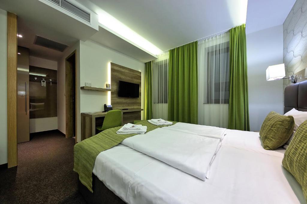 Postel nebo postele na pokoji v ubytování Nádas Tó Park Hotel