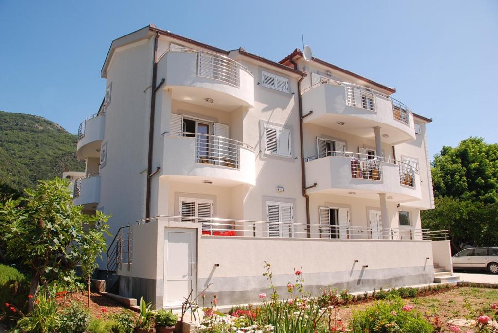 a large white building with balconies on it at Apartment Dakic in Herceg-Novi