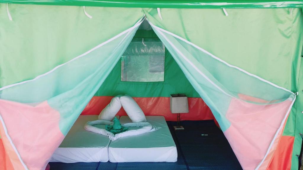 a green and pink tent with a bed in it at Koh Ngai Camping Restaurant @ Bar in Ko Ngai