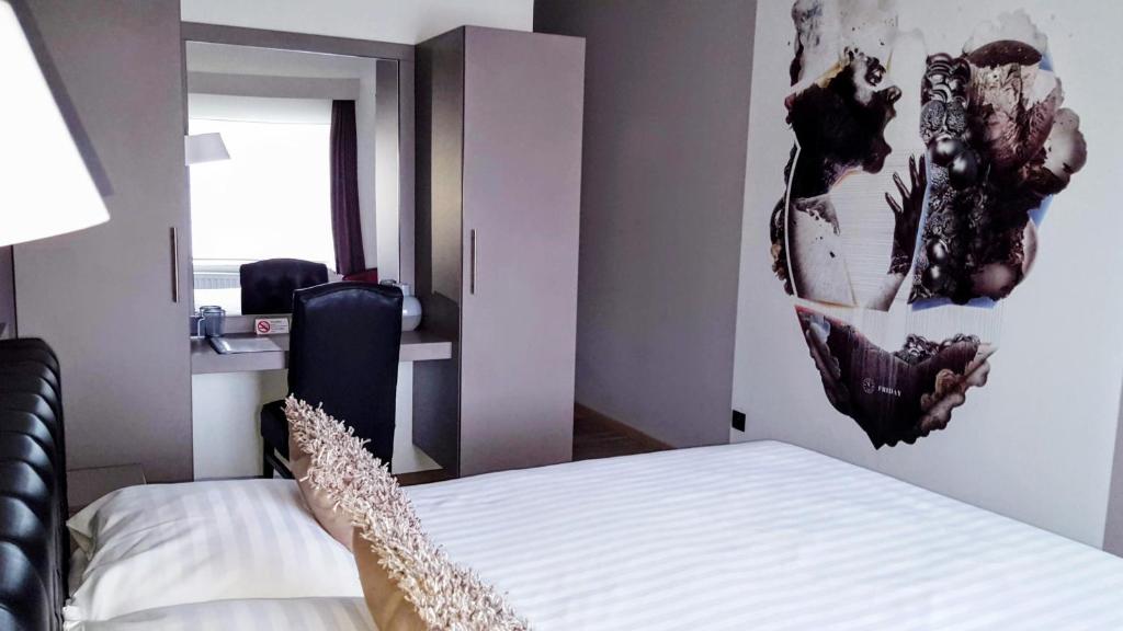 Postel nebo postele na pokoji v ubytování Belrom Hotel