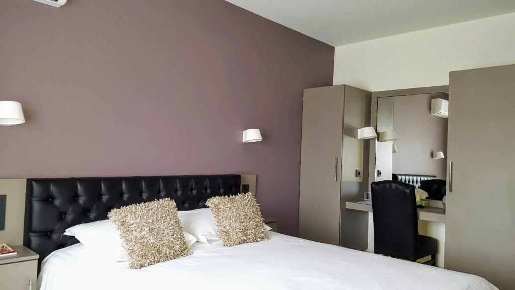 Postel nebo postele na pokoji v ubytování Belrom Hotel