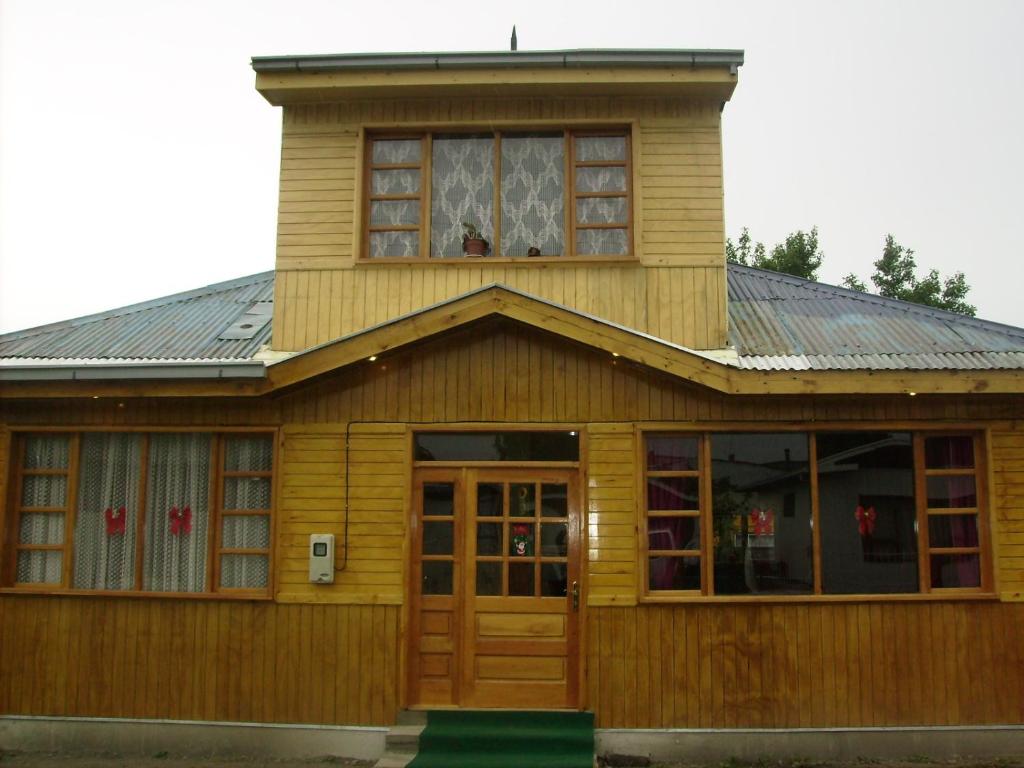 ein Holzhaus mit einem Turm darüber in der Unterkunft Hostal El Rincón in Puerto Natales