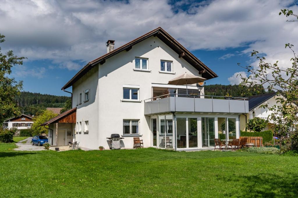 duży biały dom z dużym dziedzińcem w obiekcie Ferienwohnung Metzler - Blick auf die Berge w mieście Göfis