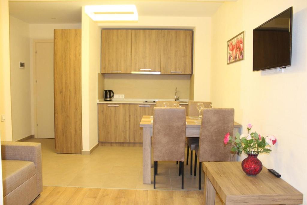 a living room and kitchen with a table and chairs at Sweet Apartment New Gudauri 3 in Gudauri