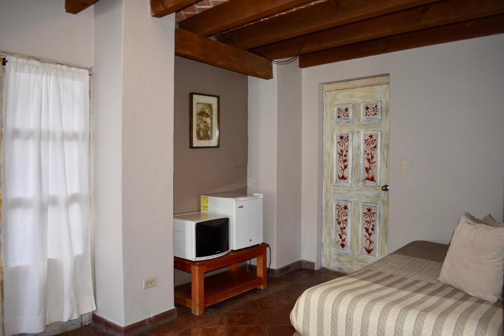 Postel nebo postele na pokoji v ubytování Hotel Ana Catalina and Suites