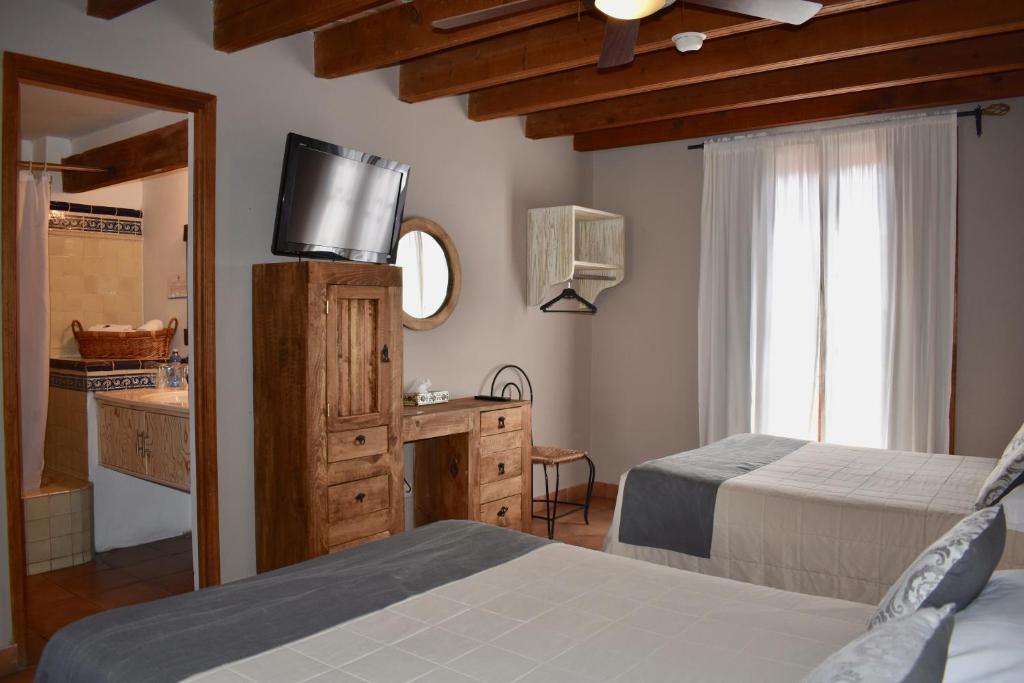 Postel nebo postele na pokoji v ubytování Hotel Ana Catalina and Suites