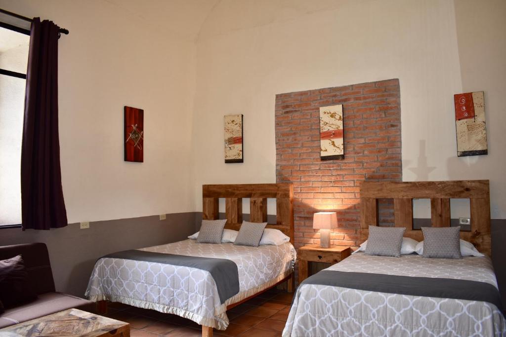 Postel nebo postele na pokoji v ubytování Hotel Ana Catalina and Suites