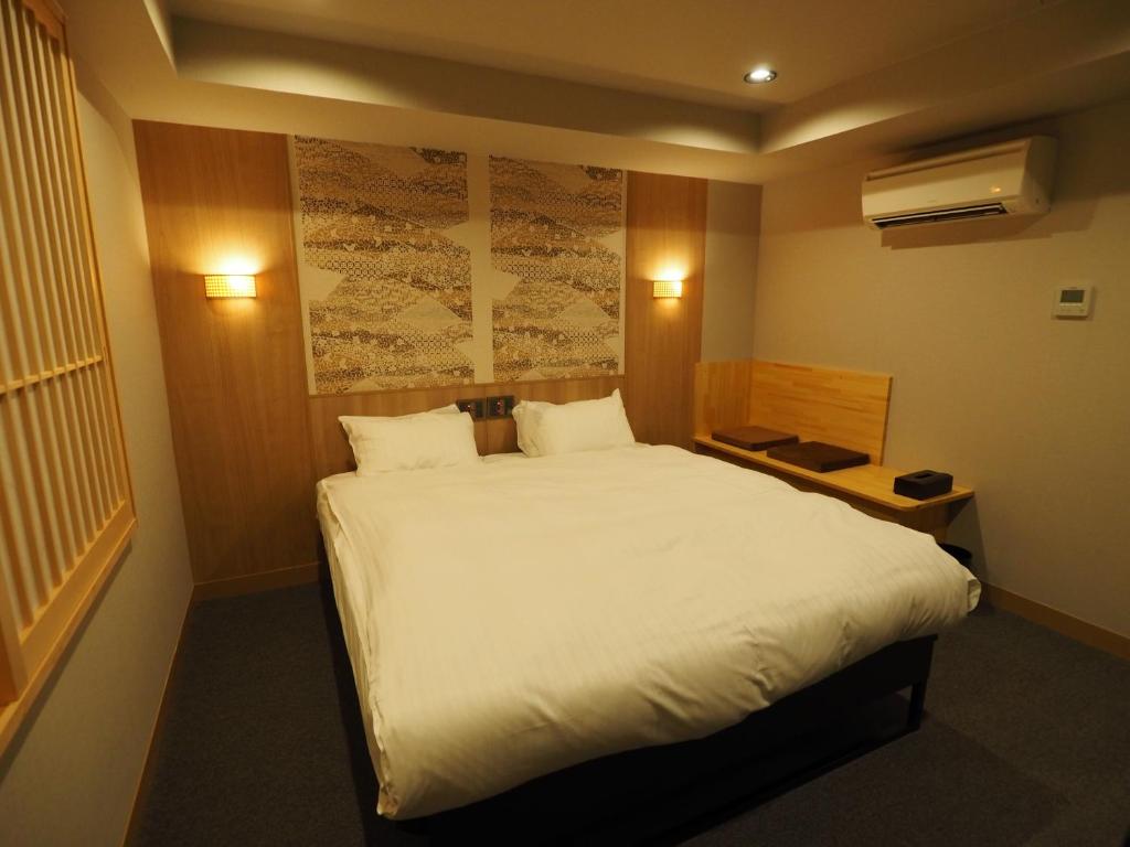 Postel nebo postele na pokoji v ubytování Hotel Be-zen shimanouchi