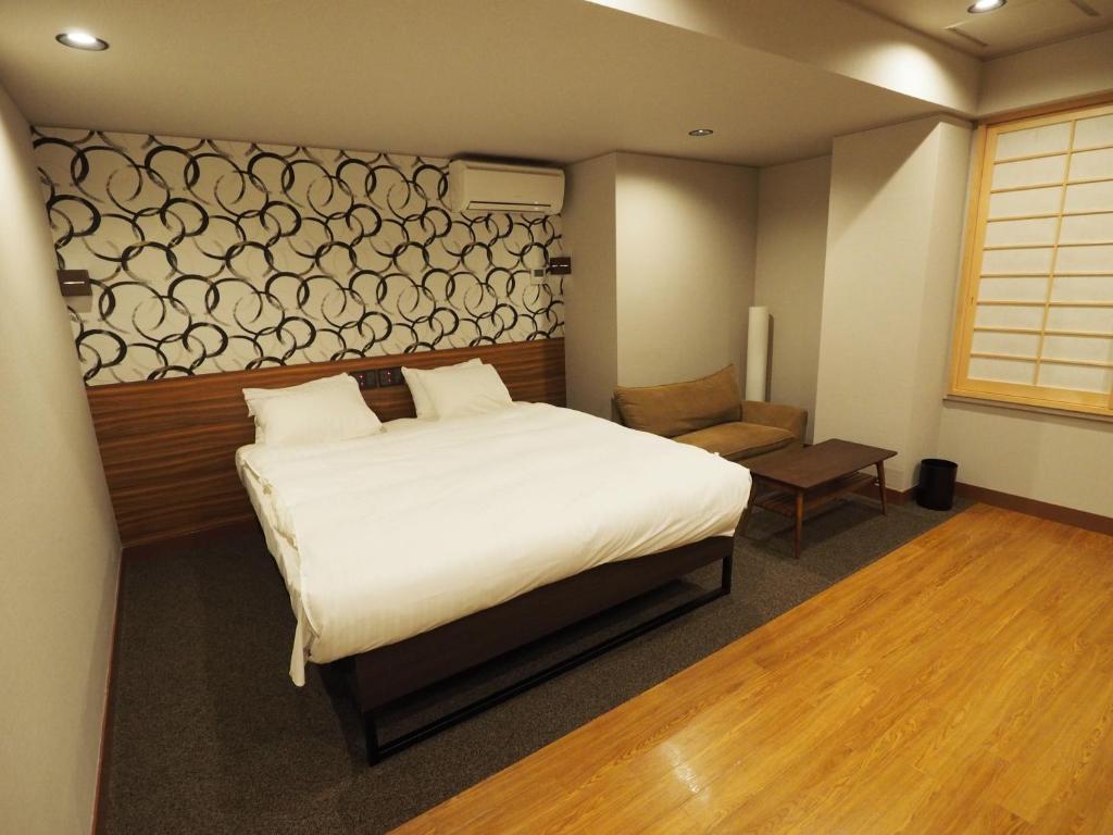 Postel nebo postele na pokoji v ubytování Hotel Be-zen shimanouchi