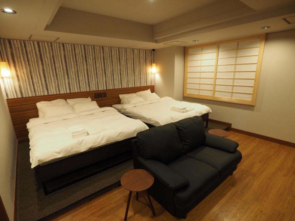 Postel nebo postele na pokoji v ubytování Hotel Be-zen shimanouchi