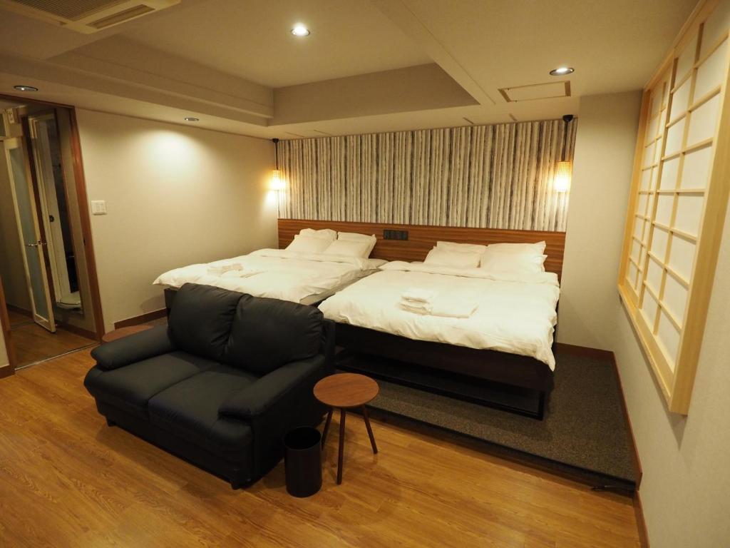 Postel nebo postele na pokoji v ubytování Hotel Be-zen shimanouchi