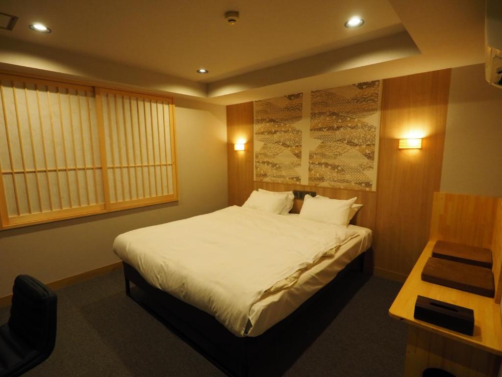 Postel nebo postele na pokoji v ubytování Hotel Be-zen shimanouchi