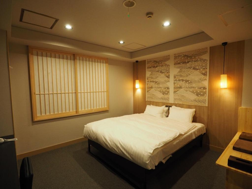Postel nebo postele na pokoji v ubytování Hotel Be-zen shimanouchi
