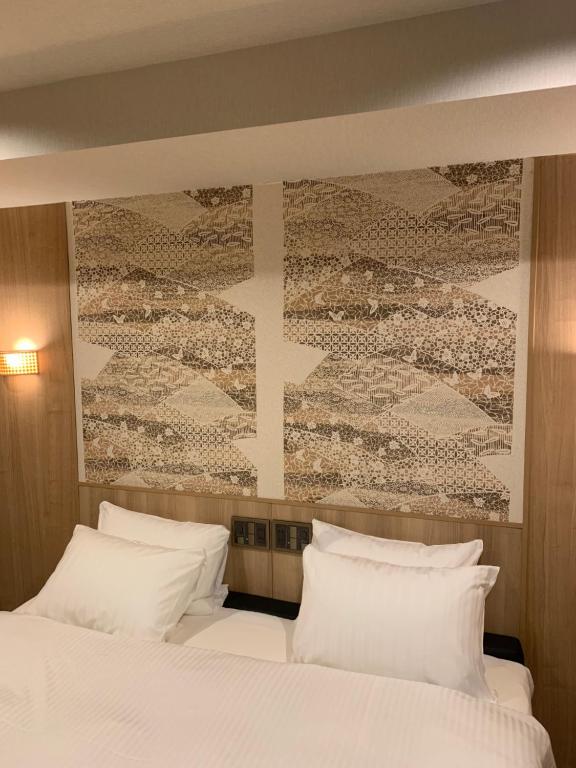 Postel nebo postele na pokoji v ubytování Hotel Be-zen shimanouchi