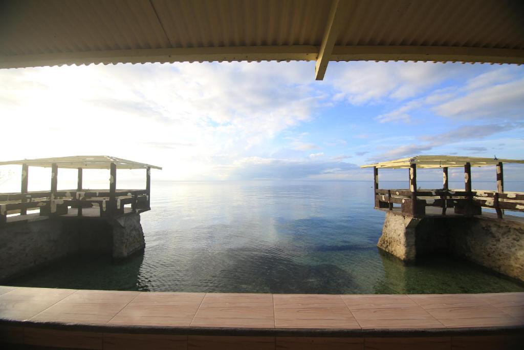 a view of the ocean from a dock at GingGing Hotel And Resort in Oslob