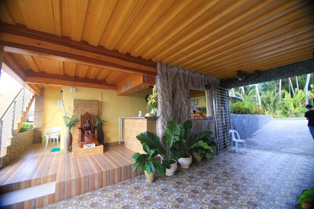 a porch of a house with potted plants at GingGing Hotel And Resort in Oslob