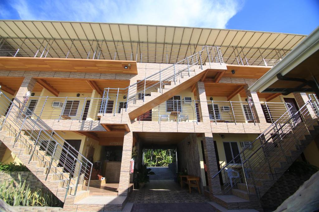 a building with stairs on the side of it at GingGing Hotel And Resort in Oslob