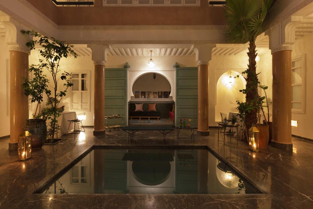 a large room with a swimming pool in a house at Riad Albatoul in Marrakech