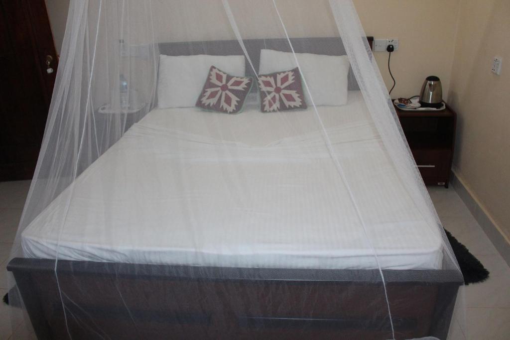 Postel nebo postele na pokoji v ubytování Pidurangala Villas