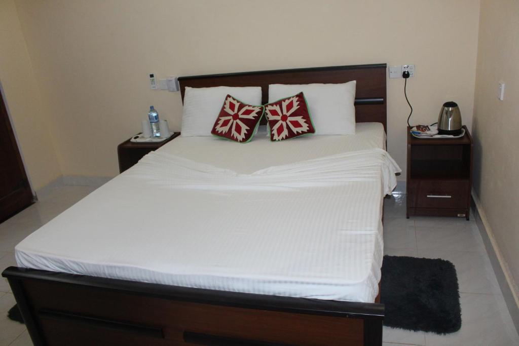 Postel nebo postele na pokoji v ubytování Pidurangala Villas