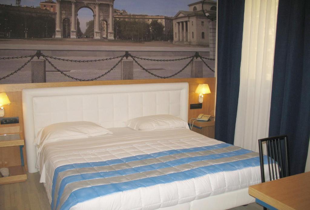 Postel nebo postele na pokoji v ubytování Hotel Domenichino