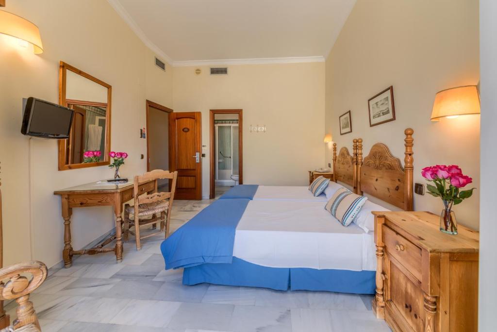 Postel nebo postele na pokoji v ubytování Hotel La Española