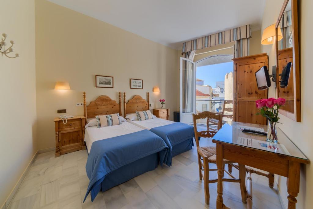 Postel nebo postele na pokoji v ubytování Hotel La Española
