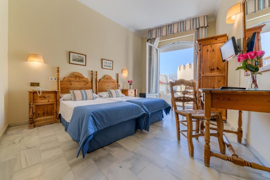 Postel nebo postele na pokoji v ubytování Hotel La Española