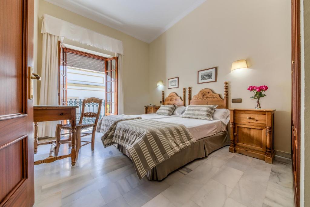 Postel nebo postele na pokoji v ubytování Hotel La Española