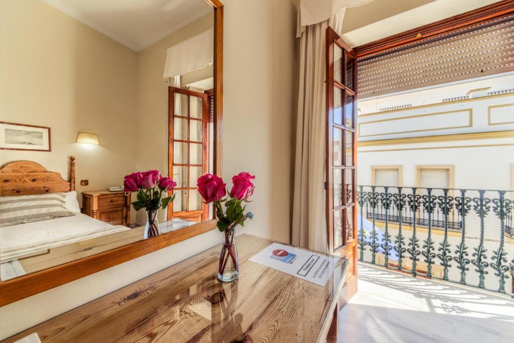 Postel nebo postele na pokoji v ubytování Hotel La Española