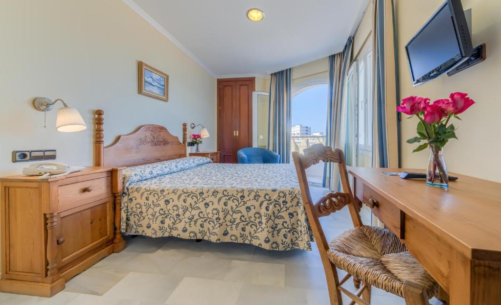 Postel nebo postele na pokoji v ubytování Hotel La Española
