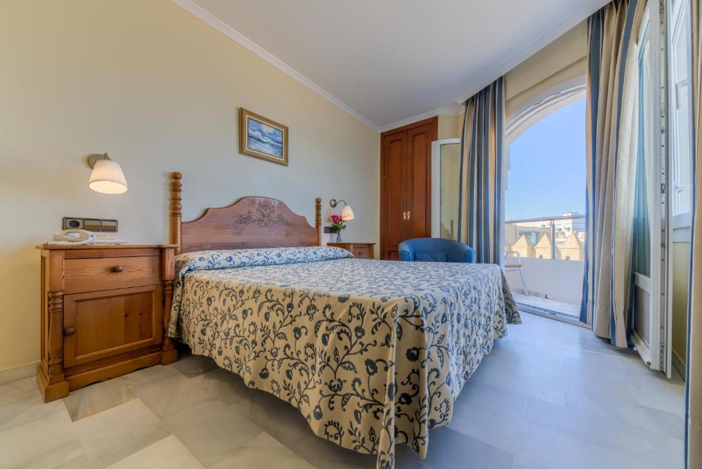 Postel nebo postele na pokoji v ubytování Hotel La Española
