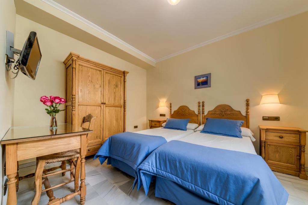 Postel nebo postele na pokoji v ubytování Hotel La Española