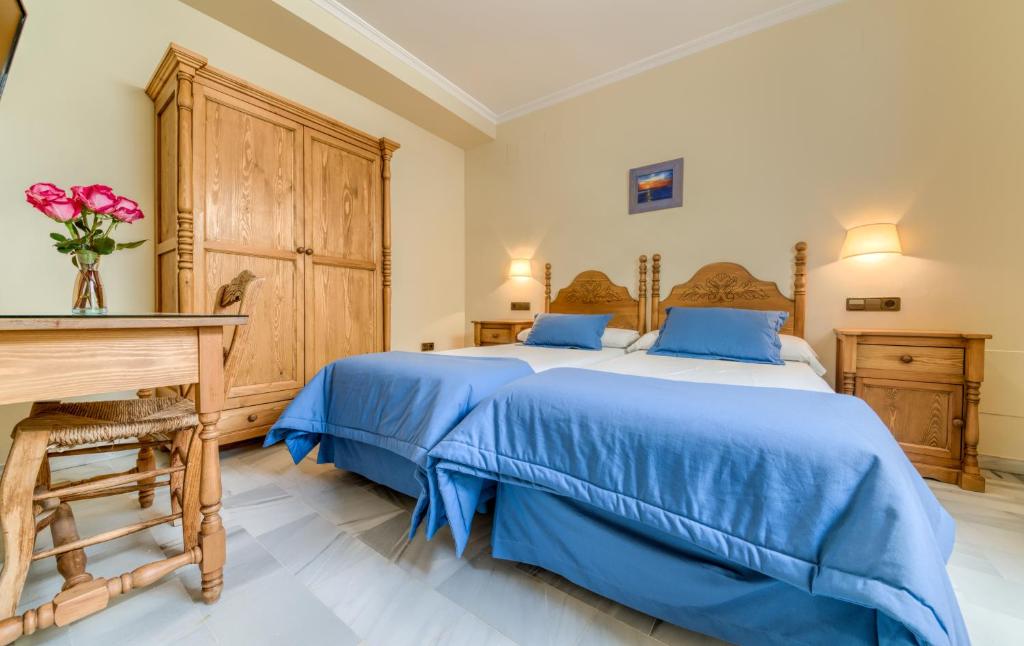 Postel nebo postele na pokoji v ubytování Hotel La Española