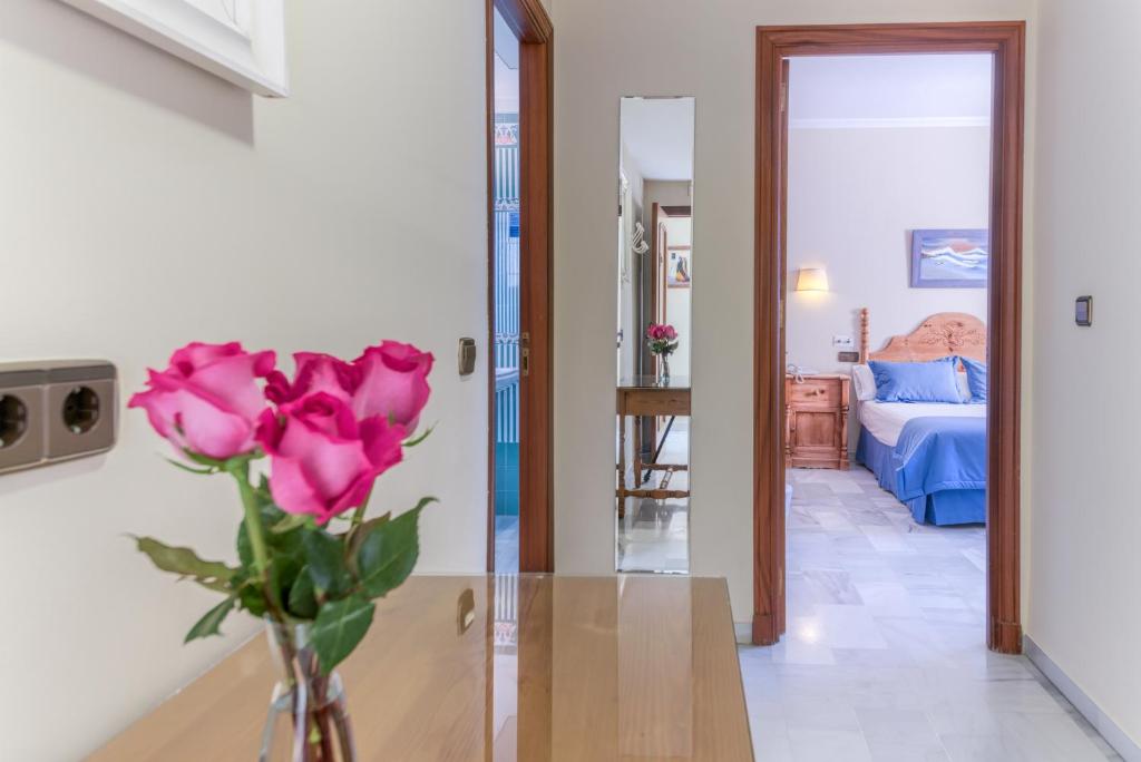 Postel nebo postele na pokoji v ubytování Hotel La Española
