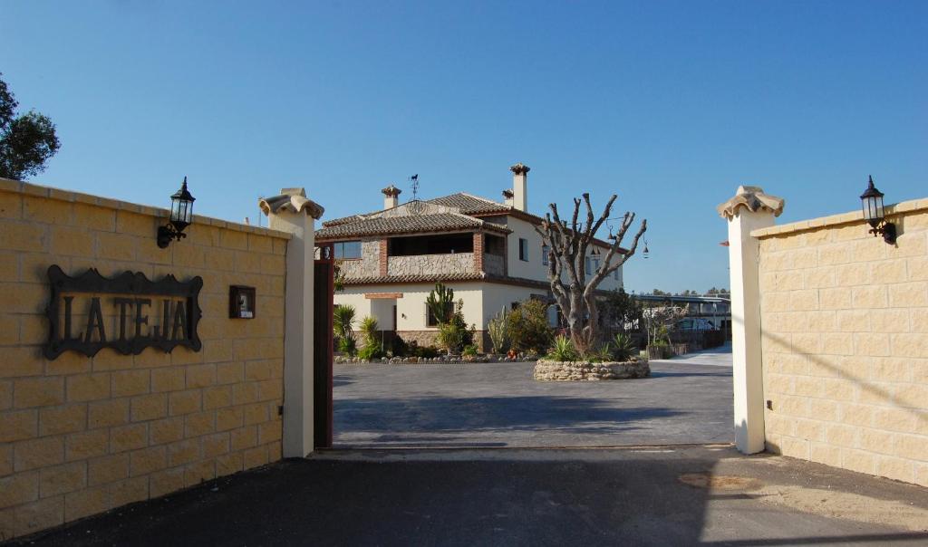 a house with a gate in front of a building at Residencial La Teja in Zahora