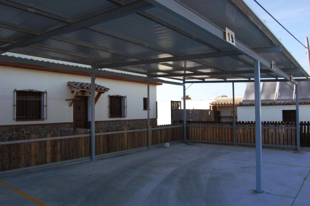 a large metal pavilion outside of a building at Residencial La Teja in Zahora