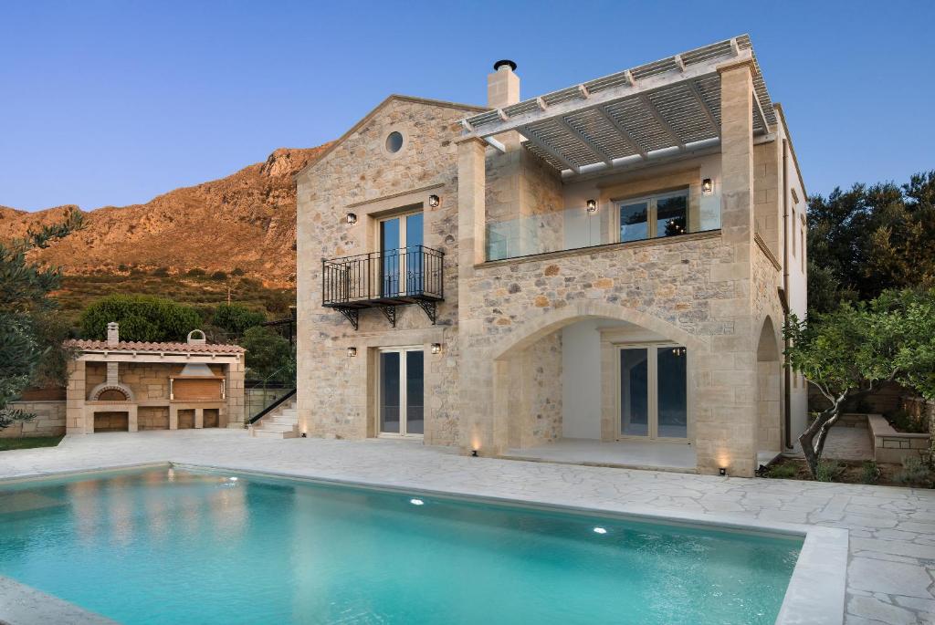 a house with a swimming pool in front of it at Villa Antonousa - Private Pool Oasis in Kerá